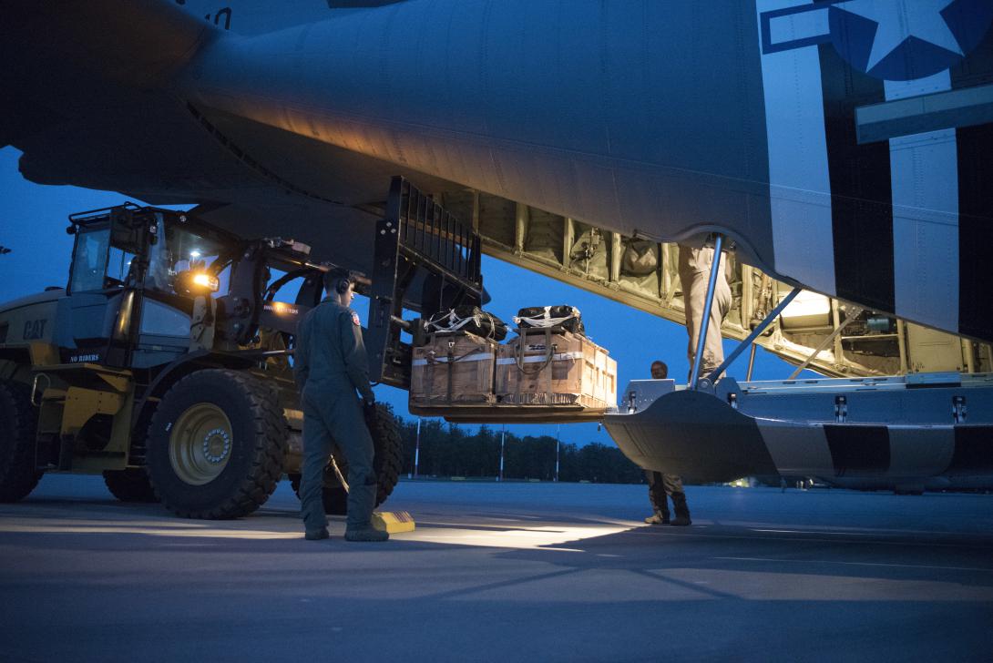 Airmen from the 37th Airlift Squadron and 86th Logistics Readiness Squadron load a low-cost low-altitude drop into a C-130J Super Hercules aircraft as the flight crew prepares for a night-time training mission during 2021 Aviation Detachment Rotation at 33rd Air Base near Powidz, Poland. The LCLA drop contents would consist of supplies or equipment for a small subset of units. Credit: U.S. Air Force photo by Senior Airman Kristof J. Rixmann