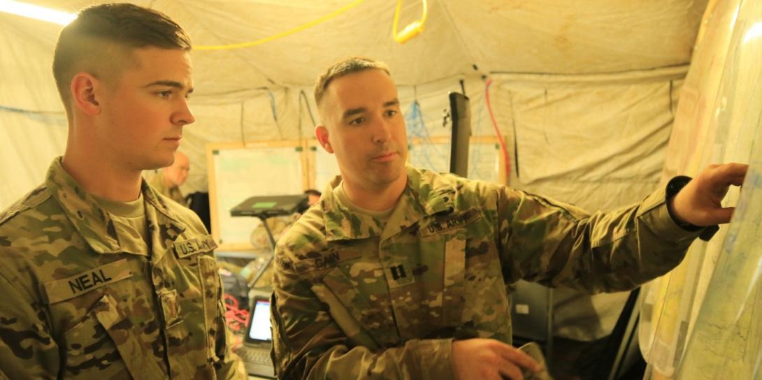2nd Lt. Shane Neal, USA, receives guidance from Capt. Douglas Gain, USA, as they review the Cyber and Electromagnetic Activities Team’s plans during Exercise Saber Junction 2019 at the Grafenwoehr Training Area, Germany. Credit: U.S. Army