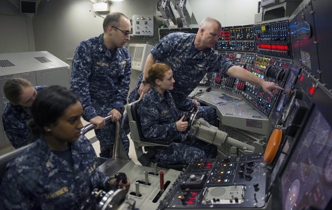 A group of Naval ROTC midshipmen practice driving a simulated submarine in the ship's control trainer at the Trident Training Facility in Bangor, Washington. The midshipmen toured the facility as part of their summer cruise to learn more about the Navy and their career options.