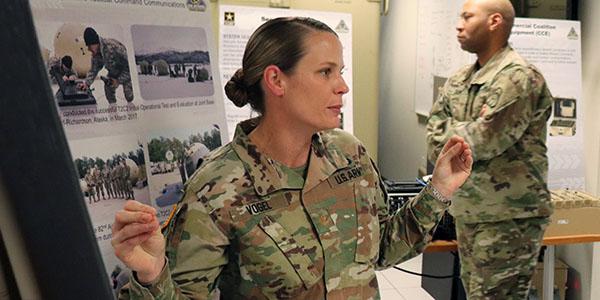 Maj. Jennifer Vogel, USA, explains the benefits of the Transportable Tactical Command Communications (T2C2) capability to SIGNAL Magazine and other reporters during a recent visit to the PEO C3T.