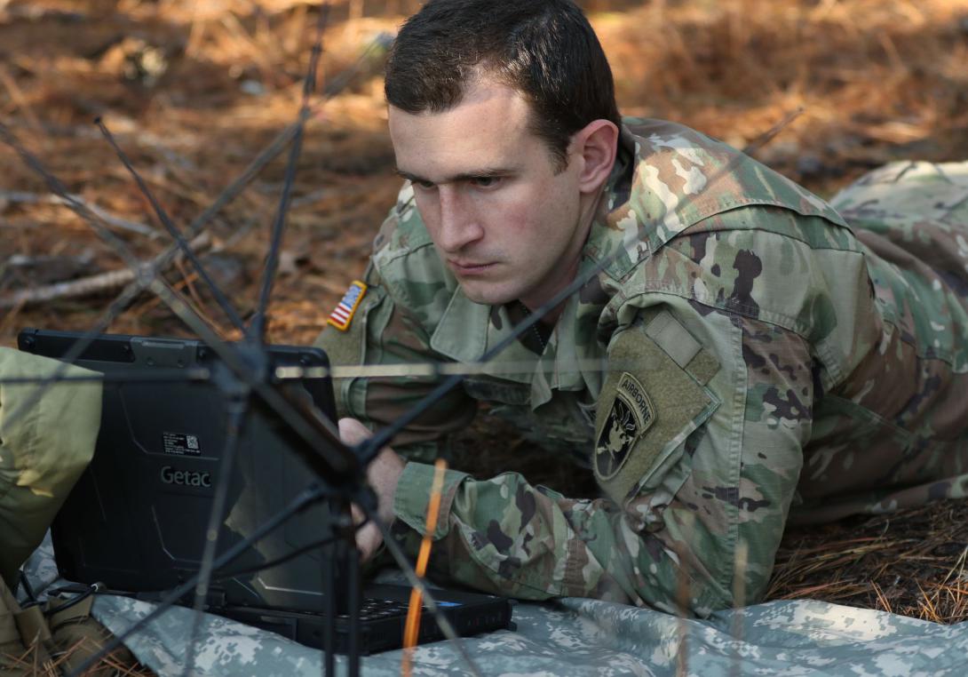 A student assigned to the U.S. Army John F. Kennedy Special Warfare Center and School, who is in the Special Forces Communications Sergeant course, trains using a PDA-184 computer and an AN/PRC-117G satellite radio during training at the Yarborough Training Complex at Fort Bragg, North Carolina.  U.S. Army photo by K. Kassens