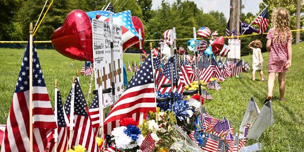 Chattanooga residents create makeshift memorials to honor and remember the victims killed by a gunman. The event raises questions about the public's view on intelligence services.