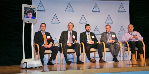 Dallas Goecker joins a panel discussion on mobility from Indiana via a robotic telepresence device developed by Suitable Technologies to facilitate remote collaboration. Goecker was a panelist at Mobile Tech Summit held in Washington, D.C. Photo by Mike Carpenter