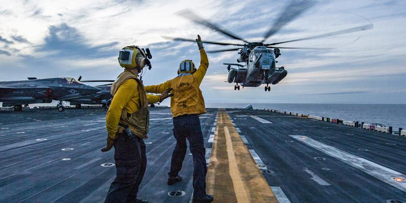 Sailors assist with the landing of a Marine Corps CH-53E Super Stallion helicopter on the deck of the U.S. Navy’s USS Wasp assault ship as part of an April certification exercise in the Philippine Sea. In its role of steering the Navy toward the best information technology for the 21st century, the Space and Naval Warfare  Systems Center (SSC) Atlantic is looking at cloud computing systems to support the warfighter. Credit: Petty Officer 3rd Class Levingston Lewis, USN
