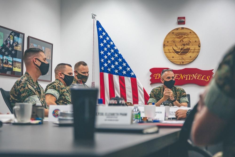 U.S. Marine Corps Lt. Gen. Matthew G. Glavy (right center), deputy commandant for information (DCI), discusses operational topics during a brief at the I Marine Expeditionary Force Information Group headquarters, Marine Corps Base Camp Pendleton, California, in September 2021. The DCI plans to expand the Information Development Institute’s learning platform, which is presently reaching 400 civilian users.  U.S. Marine Corps photo by Cpl. Andrew Skiver
