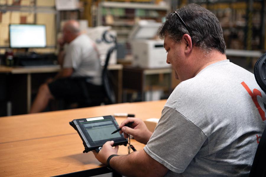 Naval Supply Systems Command Business Systems Center staff supports Fleet Logistics Center–Jacksonville warehouse employees using Naval Mobile Computing tablets. The center provides the Navy with information systems support through the design, development and maintenance of information systems in the functional areas of logistics, supply chain management, transportation and finance. U.S. Navy photo by James E. Foehl/Released