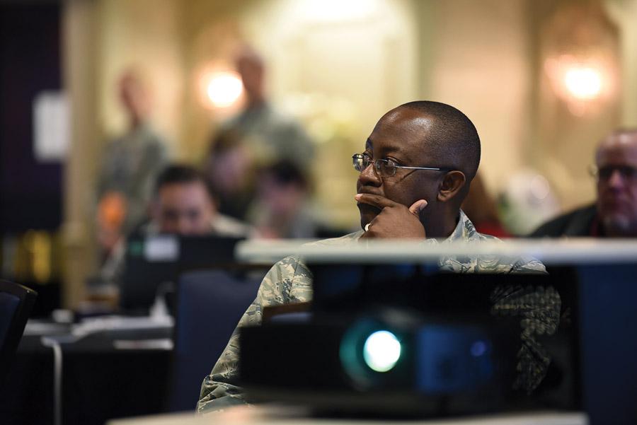 A U.S. Air Force officer listens to a briefing during the 635th Supply Chain Operations Wing Logistics Readiness Squadron annual summit. During the briefing, participants had the opportunity to hear and learn from members of the highest levels of the Air Force logistics community. U.S. Air Force photo by Airman 1st Class Solomon Cook, USAF