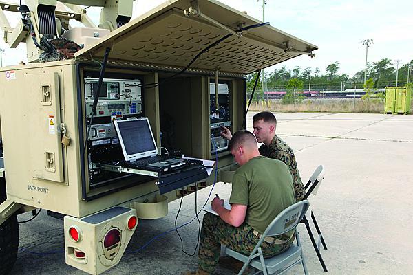The U.S. Marine Corps is developing a private cloud computing environment to provide better information services to the tactical edge. Here, communicators set up a Support Wide Area Network System during a training exercise.