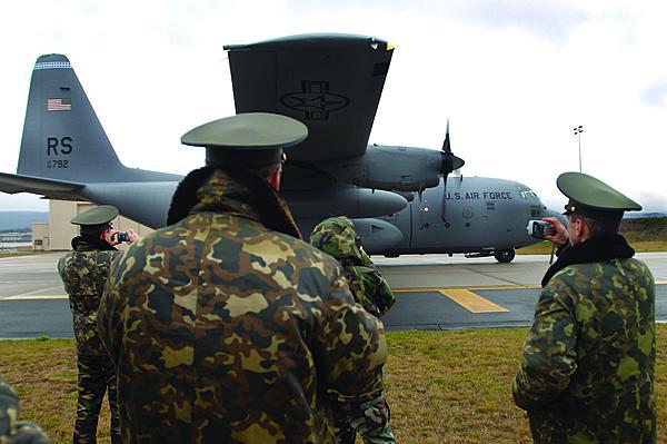 Russian air force officers take photos as a C-130 Hercules prepares for a combat offload demonstration at Ramstein Air Base, Germany. The United States must find ways to work with Russia ibecause of the latter’s nuclear capabilities and position in the world.