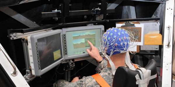 A soldier operates systems in a simulated tank while scientists at the Army Research Laboratory (ARL) monitor his brain waves. This work by the ARL’s Combat Capabilities Development Center seeks to establish how artificial intelligence can be employed to address a soldier’s needs by determining changes in the human’s mood.  ARL photo