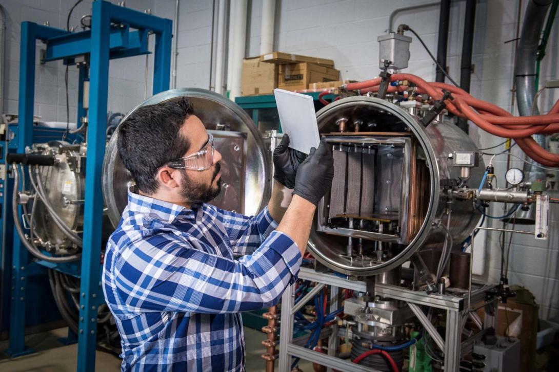 A materials engineer with the ARL examines a novel material sample at a laboratory in Aberdeen Proving Ground. This is one of several ARL efforts to develop stronger and lighter materials to protect warfighters.  David McNally/U.S.Army