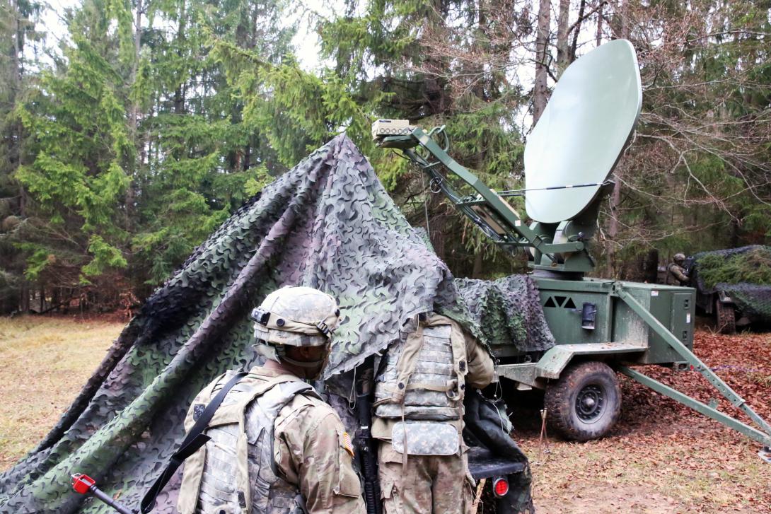 U.S. soldiers with the 2nd Theater Signal Brigade camouflage a satellite transportable terminal and its generator. The ARL’s IoBT research seeks to make better use of available bandwidth as it adds diverse data to the network.