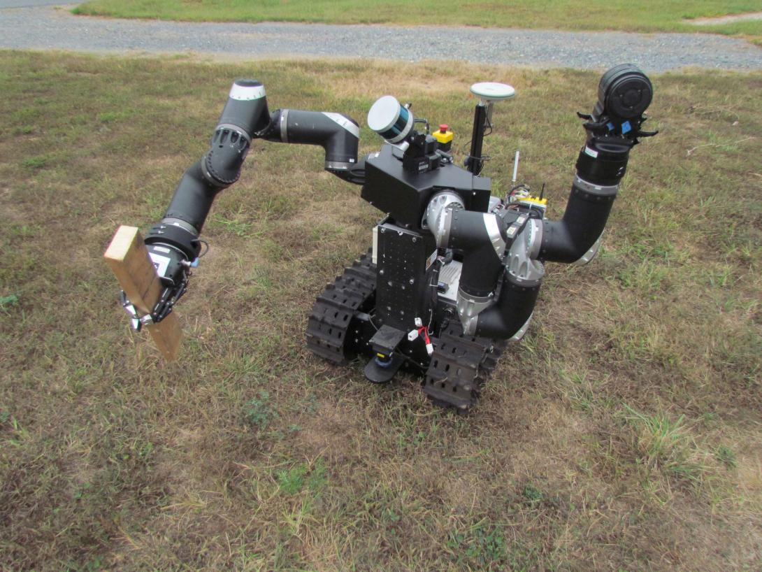 A small robot grasps a piece of wood as a test of its ability to remove obstacles from its path. The ARL’s testbed at Graces Quarters will enable researchers to test robotic capabilities against real-world scenarios such as fallen tree limbs or artificial barricades in the field.  U.S. Army photo