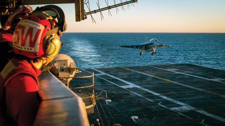 An EA-18G Growler electronic warfare (EW) aircraft lands on the deck of the USS Carl Vinson. The Naval Information Forces command includes EW and other non-kinetic activities as part of its thrust toward integrated fires. U.S. Navy photo