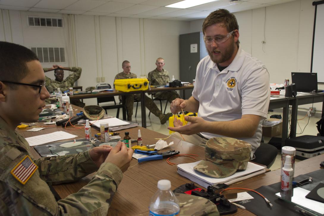 A contracted instructor teaches soldiers how to splice a fiber cable during a Fort Hood Signal University class. Giving soldiers extensive knowledge of their network would have the effect of returning network ownership to its users.