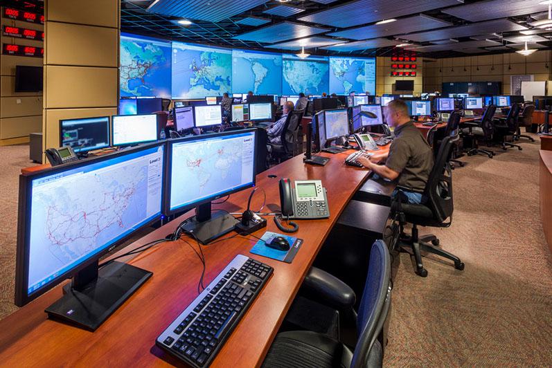 Officials in a telecommunications control room monitor network activity. Having accurate situational awareness of optical fiber traffic is a key to maintaining connectivity amid a range of threats, both accidental and deliberate. Credit: CenturyLink