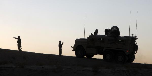 U.S. Marines conduct operations in Afghanistan as part of the International Security Assistance Force. The NATO Secret-level network in Afghanistan, outsourced to private industry, serves as an example of how future NATO information technology might be acquired through outsourcing.