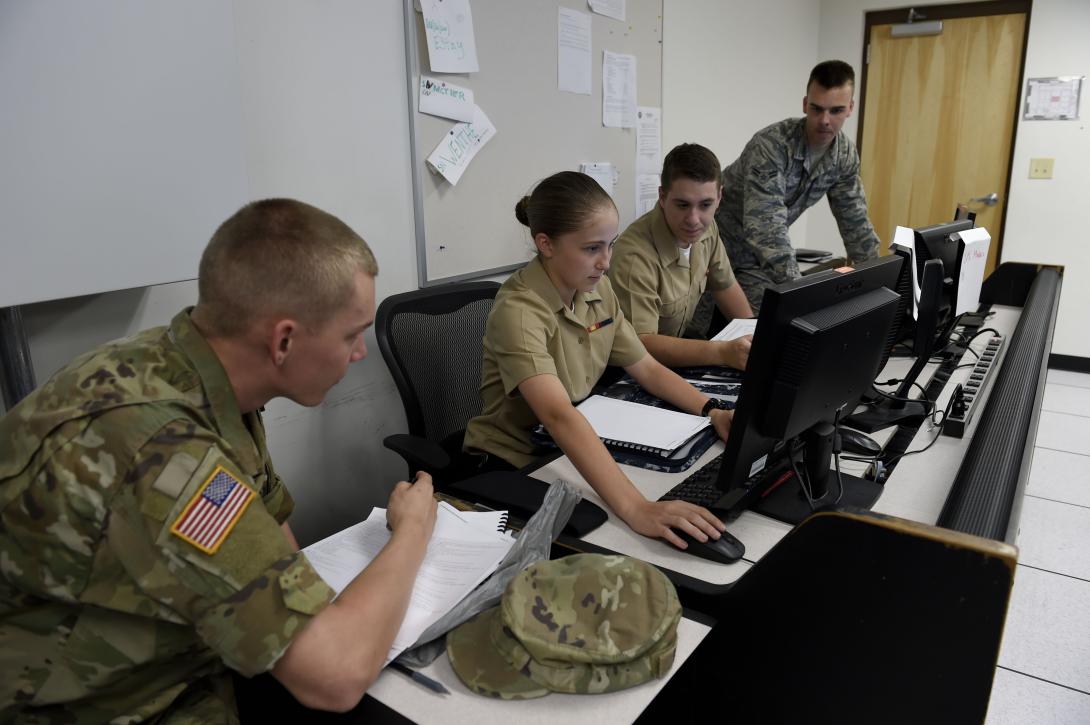 Two Navy cryptologic technicians track a target of interest from the electronic warfare combat direction center of the USS Dwight D. Eisenhower. Electronic warfare, signals intelligence and cyber increasingly are overlapping in combat operations.