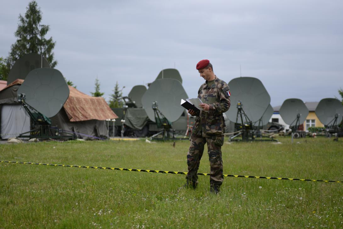 A French officer reviews notes in front of communications antennas during NATO’s Steadfast Cobalt 15 exercise, held from late May to early June in Poland. The exercise evaluated communications and information system requirements for the NATO Response Force, which will be stood up next year.