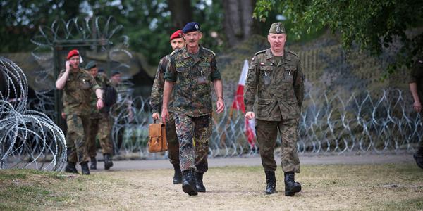 Maj. Gen. Thomas Franz, GEAF, former commander of the NATO Communications and Information Systems Group (NCISG) (c), walks with other participants during Steadfast Cobalt 15. About 39 organizations from 25 nations contributed to the exercise.