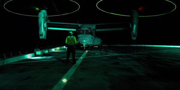 An aviation support equipment technician directs an MV-22B Osprey on the deck of the USS San Diego in the South China Sea. Operations in the vast Indo-Asia-Pacific region are increasing in complexity concurrent with rising challenges.