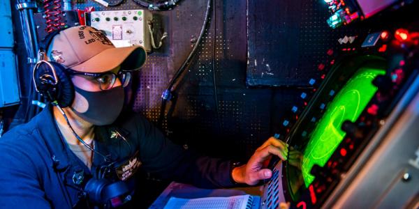 A U.S. Navy operations specialist uses a radar system in a combat information center in the 7th Fleet area of operations. The U.S. Navy’s PEO C4I and Space Systems is focusing on parallel development of digital assets and capabilities to speed innovation to the fleet. Credit: U.S. Navy