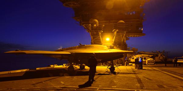 An X-47B unmanned aircraft undergoes nighttime testing aboard the USS Theodore Roosevelt. Better integration of platforms and sensors is one goal of the U.S. Navy’s Program Executive Office (PEO) for Unmanned Aviation and Strike Weapons.