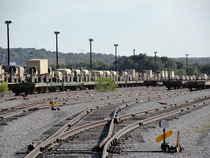 U.S. military vehicles are loaded onto railroad flatcars for transportation to locations within the United States. Foreign cyber intrusions offer the potential for adversaries to learn about logistics support as well as to change information in manifests, thus denying vital supplies to U.S. forces at key moments.