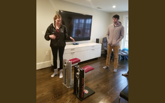 Virginia Tech students work on a device that allows a veteran missing an arm to do pushups and planks in her home. The Quality of Life Plus (QL+) program brings together injured veterans and engineering students who craft solutions to physical challenges the warriors face.  QL+ photo