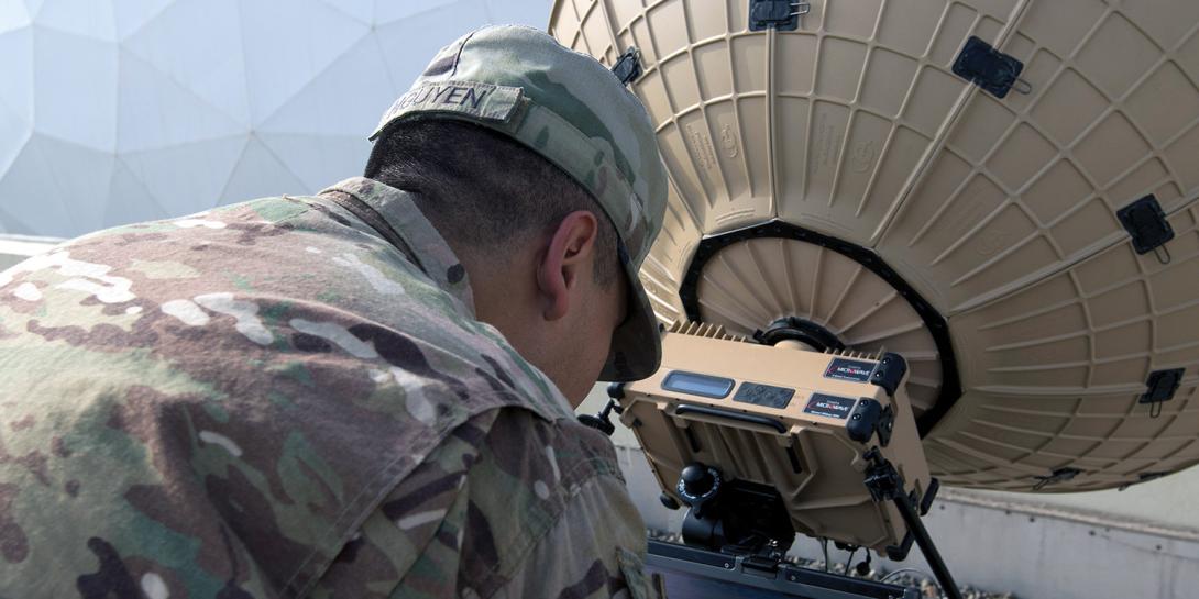 Sgt. Kevin Nguyen, USA, a team leader in the 50th Expeditionary Signal Battalion, tests the connection of a Tampa Microwave satellite dish in Camp Arifjan, Kuwait. A team of soldiers from the 50th ESB is testing the mobility and capabilities of their new equipment in locations all over the world. U.S. Army photo by Sgt. Adam Parent, USA