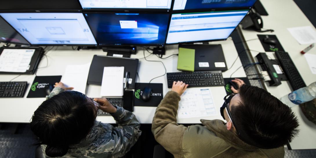 Senior Airman Rose Li, USAF (l), and Airman 1st Class Eric Gardella, USAF, 86th Communications Squadron wing cyber readiness technicians, monitor malicious network activity during exercise Tacet Venari at Ramstein Air Base, Germany, in 2020 to prepare local cyber defenders in safeguarding critical technological infrastructures. U.S. Air Force photo by Staff Sgt. Devin Boyer