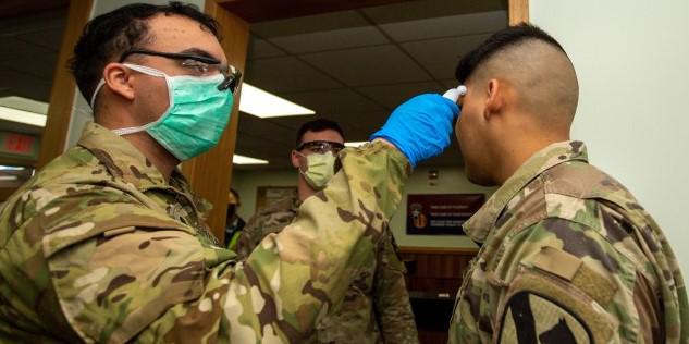 Soldiers stationed at Camp Casey conduct pre-screening processes on individuals awaiting entry to the base in South Korea, Feb. 26, 2020. The Army likely will see permanent changes to tactics, techniques and procedures due to the pandemic, says Lt. Gen. Bruce Crawford, USA, the service’s retiring CIO/G-6. Credit: Sgt. Amber Smith