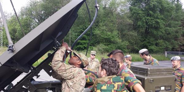 U.S. soldiers from the 2nd Theater Signal Brigade and Belgian soldiers from the 6th Communication and Information Systems (CIS) Group pass voice and data through a Belgian satellite terminal during Operation Combined Lightning last June.