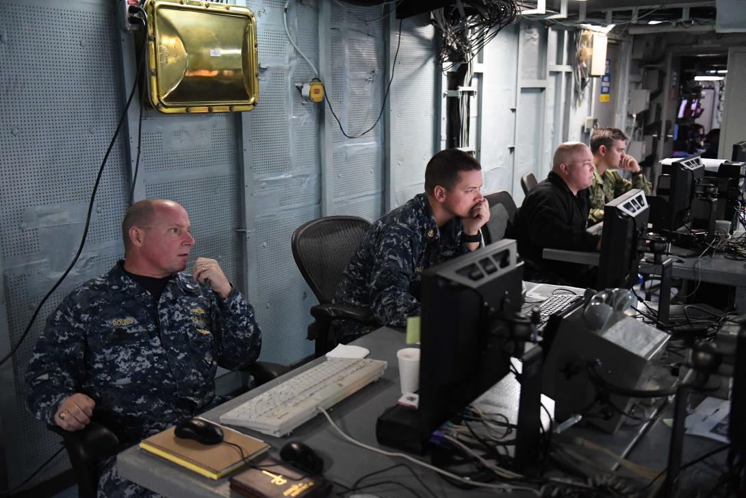 A senior Navy meteorology and oceanography officer and his team monitor computers aboard the command and control vessel USS Mount Whitney during the U.S. European Command’s computer-assisted exercise Austere Challenge 17. The annual large-scale defense exercise consists of computer-based command post simulations to train and prepare headquarters staffs for crises.