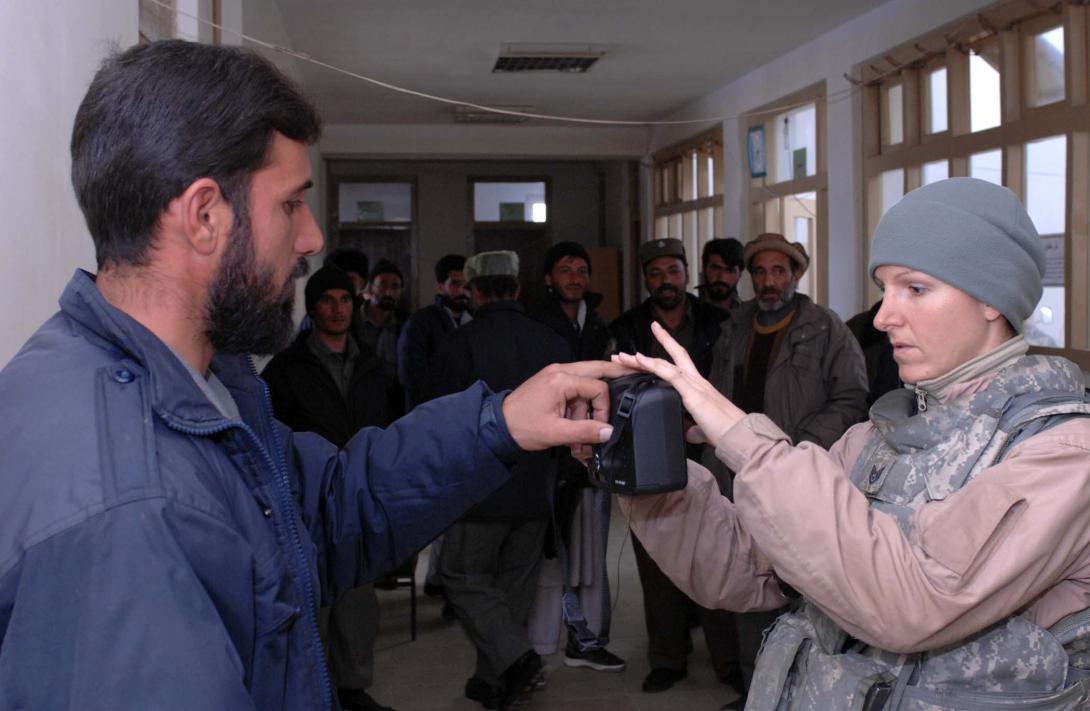 An Afghan policeman is fingerprinted to be part of a biometrics database used to identify local public safety personnel.
