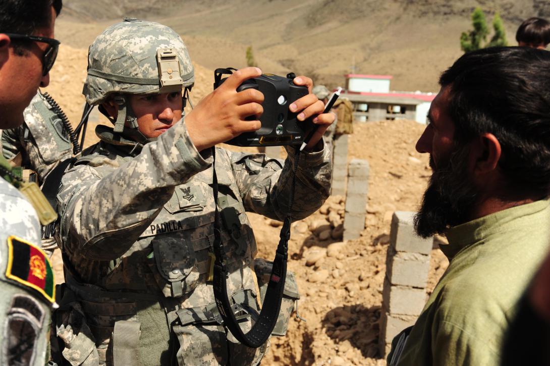 A U.S. sailor uses interagency identity detection equipment, part of the automated toolset to collect and store biometric data such as fingerprints and eye and facial scans.
