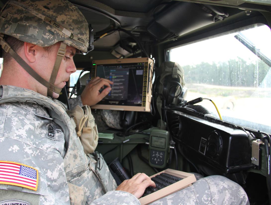 A soldier from the Experimental Force, Alpha Company, 1st Battalion, 29th Infantry Regiment, Fort Benning, Georgia, tests mobile devices for the Mission Command/Actionable Intelligence Technology-Enabled Capability Demonstration.