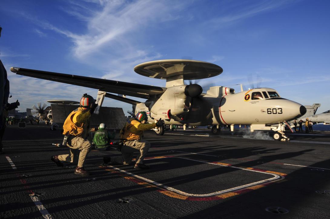 An E-2D Hawkeye assigned to the Tiger Tails of Carrier Airborne Early Warning Squadron (VAW) 125 launches off the flight deck of the aircraft carrier USS Theodore Roosevelt in October 2014.