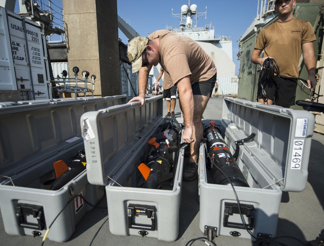 U.S. sailors from EODMU 1 perform preoperational maintenance and checks on their Remus Mk-18 Mod 1 underwater unmanned vehicles as part of a bilateral mine countermeasure exercise involving U.S. and U.K. troops.