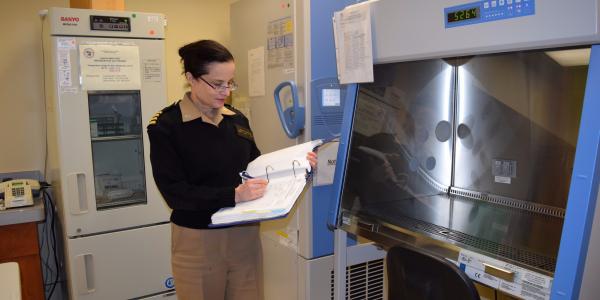 Capt. Judith Epstein, USN, clinical director of the Naval Medical Research Center’s (NMRC’s) Malaria Research Department, fills out a record book about malaria vaccine research in the clinical trials center.  U.S. Navy photo by Katie Berland