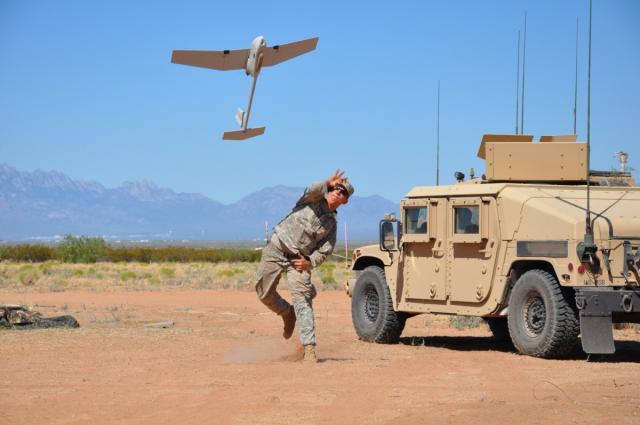 A U.S. soldier launches the Raven Unmanned Aircraft System for a test reconnaissance flight. The lightweight unmanned asset is designed for rapid deployment and mobility for military applications requiring low-altitude surveillance and reconnaissance intelligence. 