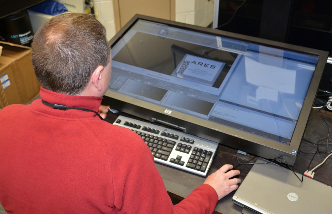A materials researcher examines experimental data on the U.S. Air Force Research Laboratory’s Autonomous Research System (ARES) artificial intelligence planner. ARES uses artificial intelligence to design, execute and analyze experiments at a faster pace than traditional scientific research methods.