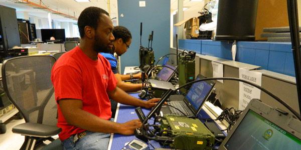 Product Manager Handheld, Manpack and Small-Form Fit engineers perform tests on the manpack radio in the Unified Lab for Tactical Radios–Army (ULTR-A) facility in Maryland. The ULTR-A lab is used for radio and waveform testing and integration.