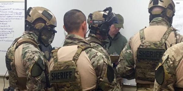 SWAT teams receive a training scenario briefing during September’s Urban Shield in California.