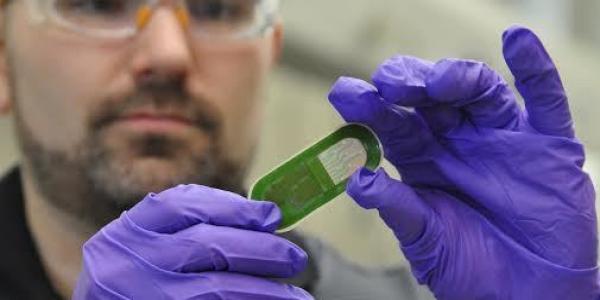An Air Force Research Laboratory researcher holds up a sweat sensor prototype. The lab’s 711th Human Performance Wing and the University of Cincinnati conducted human trials for wearable sweat sensors that could measure biomarkers and alert users to physical exhaustion, stress or possible illness.
