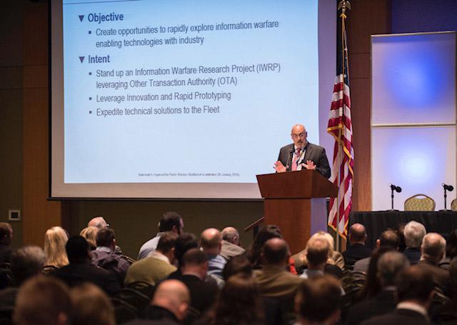 SPAWAR SSC Atlantic Deputy Executive Director William Deligne purports that the Information Warfare Research Project (IWRP) will enable rapid research and prototyping, offering the Navy innovative information warfare solutions from industry. In February, SPAWAR SSC Atlantic and Pacific leadership hosted an Industry Day, where Deligne and others spoke about alternative contracting opportunities using Other Transaction Authority (OTA), including the IWRP OTA vehicle. Credit: U.S. Navy photo by Joe Bullinger