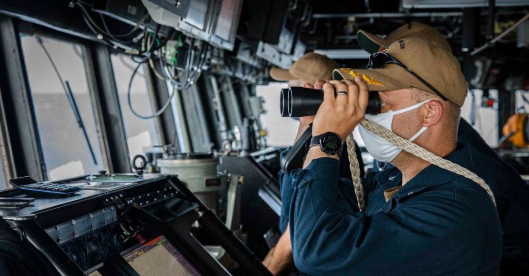 A sailor keeps watch aboard the USS John S. McCain as the guided missile destroyer asserts navigational rights and freedoms under international law in the South China Sea near the Spratly Islands. The U.S. Indo-Pacific Command (INDOPACOM) routinely conducts freedom of navigation operations as part of its mission to ensure free and secure passage in the vast region.  7th Fleet