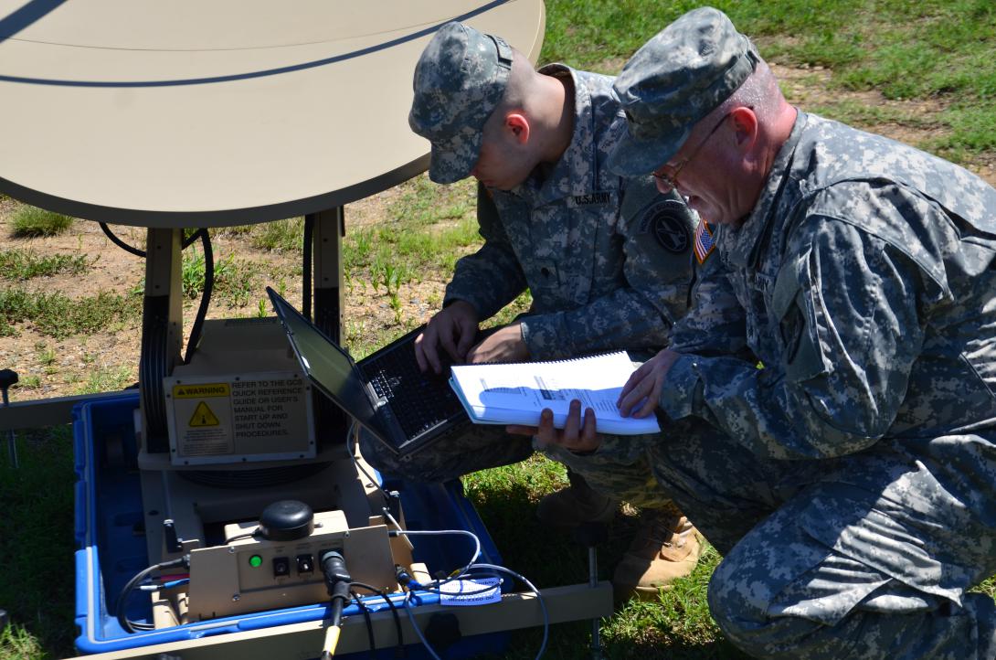 U.S. soldiers assemble a Very Small Aperture Satellite Terminal  (VSAT ) similar to the one Army Medical Command personnel rely upon for telemedicine support when forward-deployed.