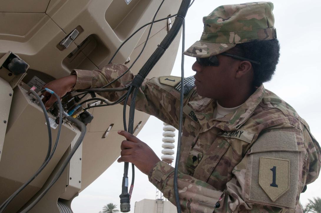 A signal support specialist with Division Headquarters and Headquarters Battalion (DHHB), 1st Infantry Division, checks out a secret Internet protocol router network (SIPRNet)/nonsecure Internet protocol router network (NIPRNet) access point, or SNAP, in Iraq. Members of the 1st Infantry Division have joined with others in the Combined Joint Forces Land Component Command– Iraq (CJFLCC-I) to build a robust communications network that can evolve over the years to come.
