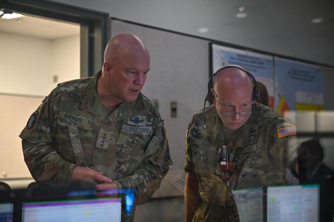 U.S. Space Force Chief of Space Operations Gen. Jay Raymond, USSF (l), and Brig. Gen. Stephen Purdy Jr., USSF, commander, Space Launch Delta 45, and director, Eastern Range, examine mission-related communication solutions at Cape Canaveral Space Force Station, Florida, in May. Space Launch Operations are supported by both the Air Force and the Space Force, providing a unique environment for operations and digital solutions such as zero trust. Credit: U.S. Space Force photo by Airman 1st Class Thomas Sjoberg